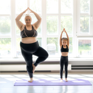 woman and child doing yoga together