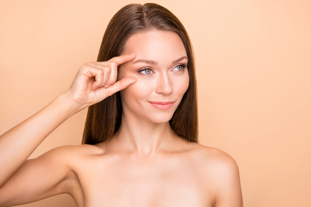 Woman pointing out wrinkle reduction from Botox.